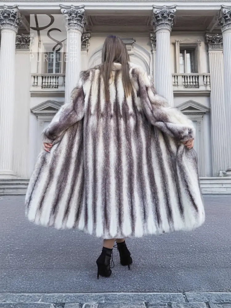 Back view of a hooded mink fur coat with flared skirt and long sleeves