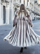 Hooded long mink fur coat with cross-stripe pattern, back view and flared hem.