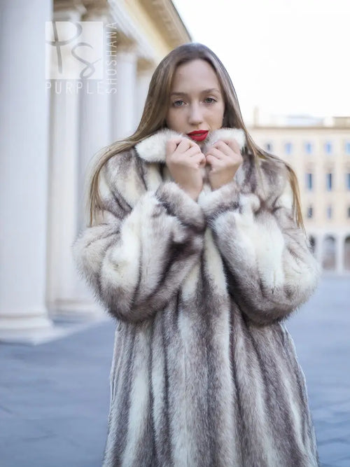 Hooded mink fur coat with dense fur texture, close-up of collar and sleeves