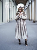 Long hooded mink fur coat with cross-stripe pattern, front view with hands at collar.