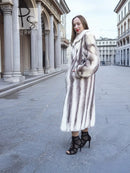Hooded mink fur coat with flared silhouette, side view with hands at pockets
