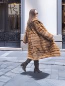 Beige pastel mink coat with shawl collar, horizontal stripe design, back three-quarter view