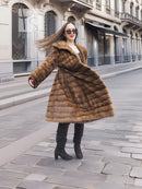 Beige pastel mink coat with shawl collar, horizontal stripes, full length front view