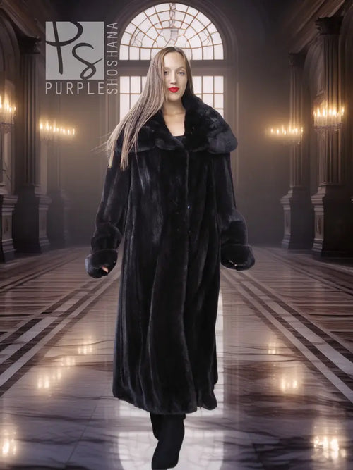 Black hooded long fur coat with buttonless open front and plush collar, worn with boots