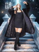 Black long hooded fur coat with flowing hem and open front, worn over a short black dress