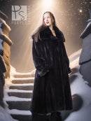 Black hooded long mink coat with silk lining; standing view with draped sleeves.