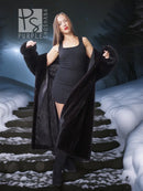 Black long hooded fur coat with open front and plush sleeves, worn over a short black dress