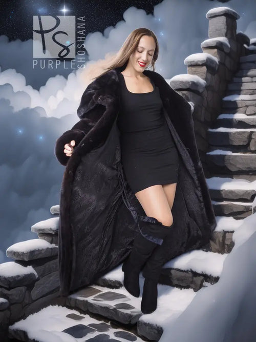 Black hooded long mink coat with silk lining; side view with open front and hooded collar.