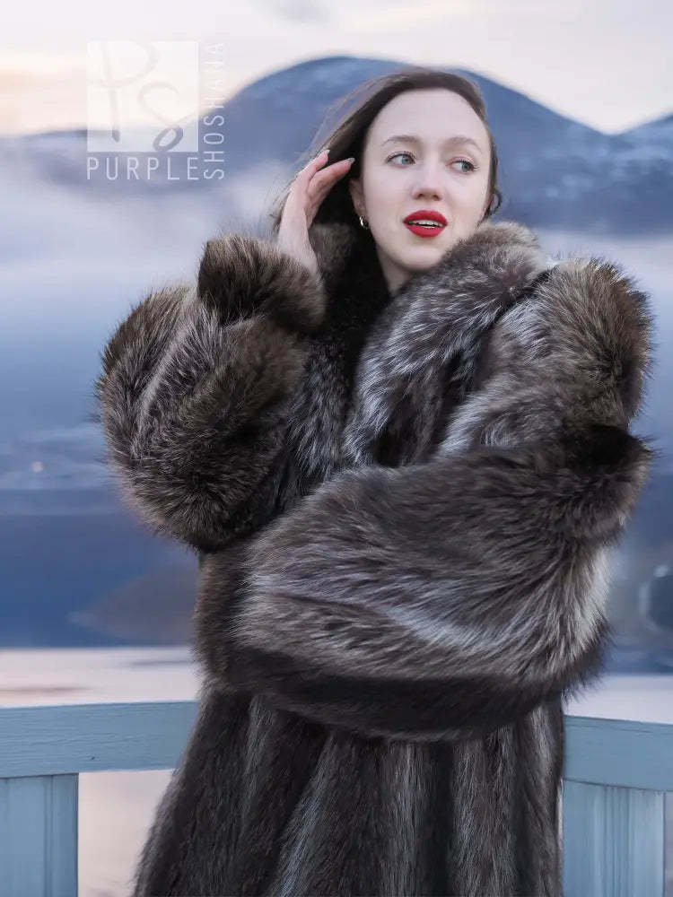 Long raccoon fur coat close-up showing thick collar and wide fur cuffs on dark gray coat