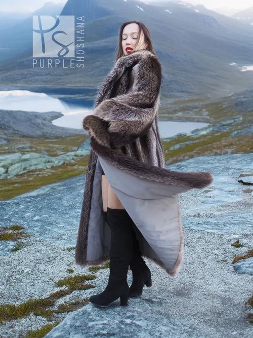 Long raccoon fur coat, dark gray, draped shoulders and flared sleeve cuffs over light dress
