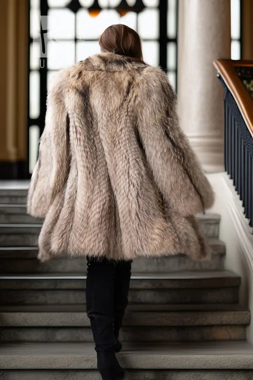 Raccoon fur coat back view with full, flared shoulders and mid-length hem