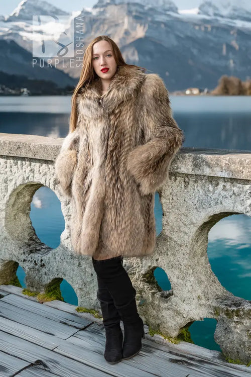 Honey raccoon fur coat with high collar and full, flowing silhouette in chestnut tones