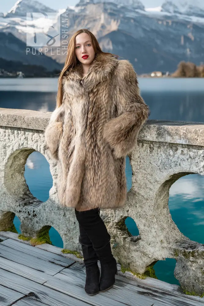 Honey raccoon fur coat with high collar and full, flowing silhouette in chestnut tones