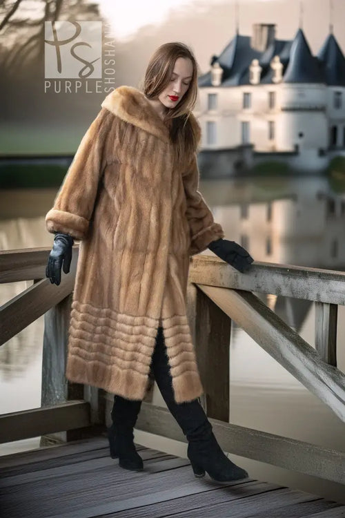 Tan mink fur hooded coat with ribbed panel detailing along the lower body