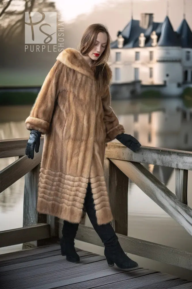 Tan mink fur hooded coat with ribbed panel detailing along the lower body