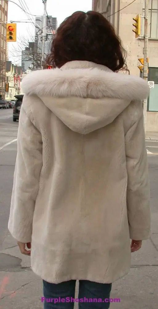 Cream hooded beaver fur coat, back view with wide fur-trimmed hood