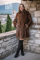 Brown mink stroller coat with high shawl collar and long, straight silhouette