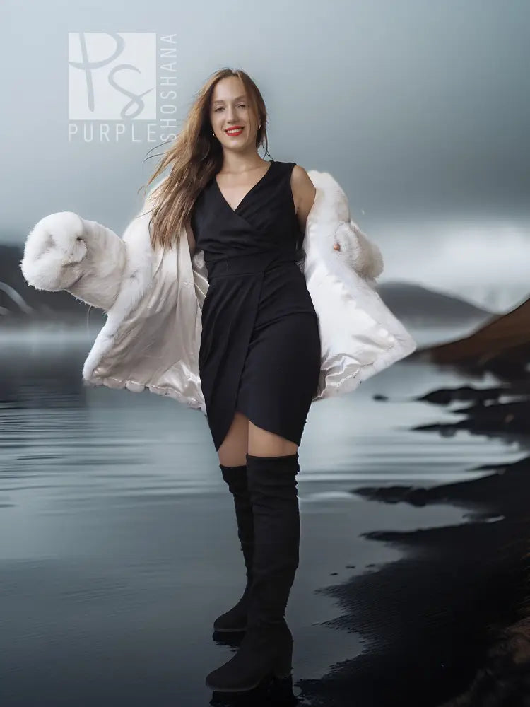 White faux fur shawl-collar coat over black dress, plush sleeve cuffs visible.