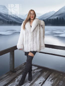 White faux fur shawl-collar coat with voluminous sleeves and cropped front length.