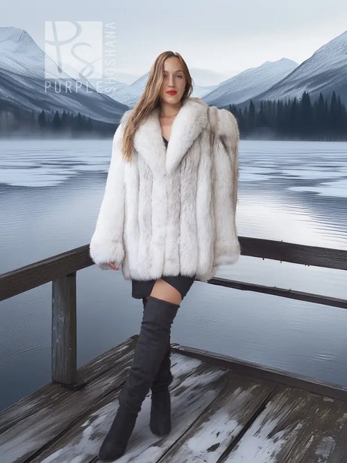White faux fur shawl-collar coat with voluminous sleeves and cropped front length.