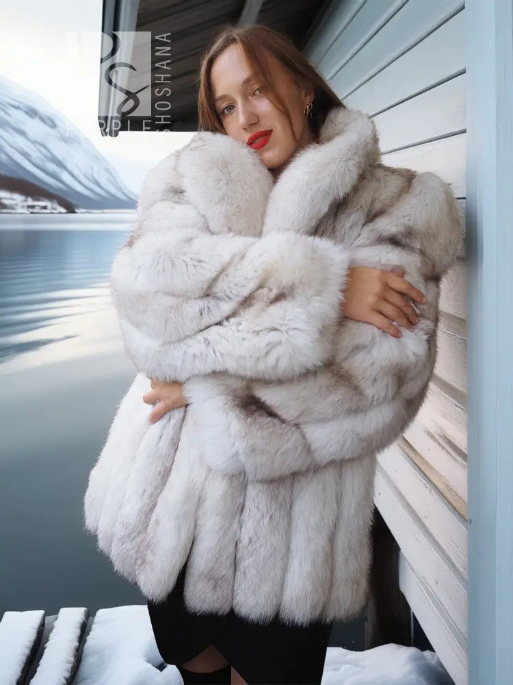 White faux fur coat with shawl collar, front wrap styling and thick fur texture.