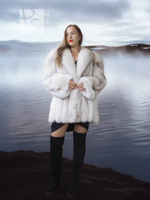 White faux fur coat with shawl collar, plush volume, front buttonless design.