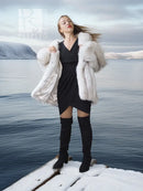 White faux fur shawl-collar coat, plush open front and voluminous sleeves for layering.