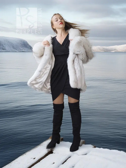 White faux fur shawl-collar coat, plush open front and voluminous sleeves for layering.