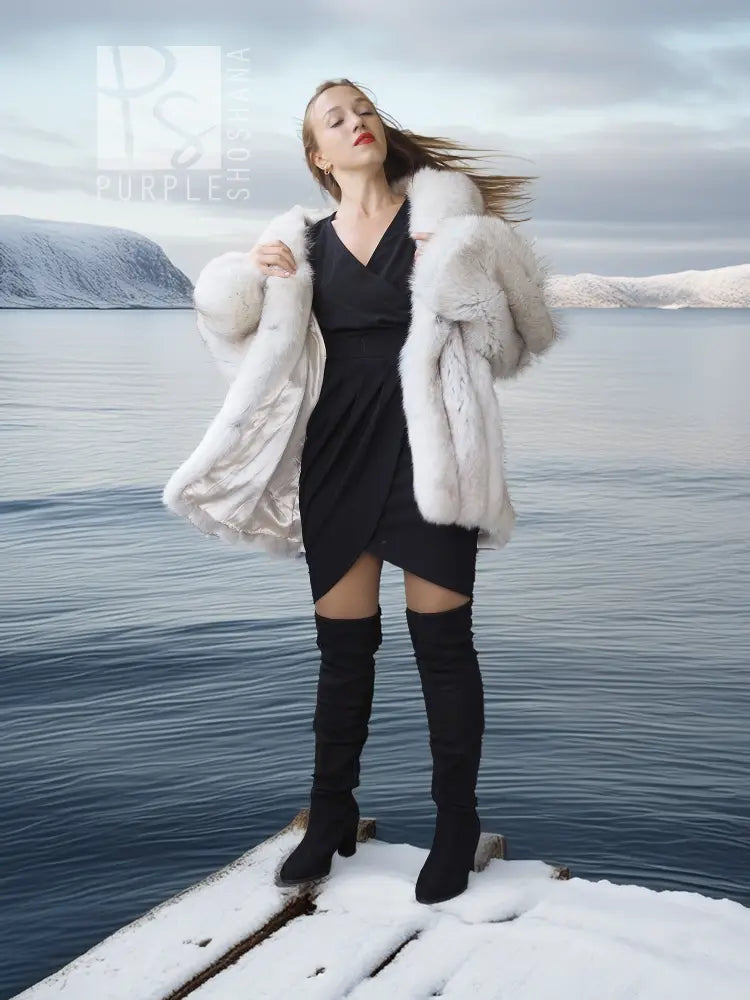 White faux fur shawl-collar coat, plush open front and voluminous sleeves for layering.