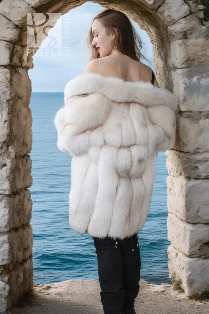 Ivory faux fur jacket shown from back, with fluffy collar and long sleeves