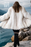 White plush fur jacket with wide layered sleeves and open front, draped look