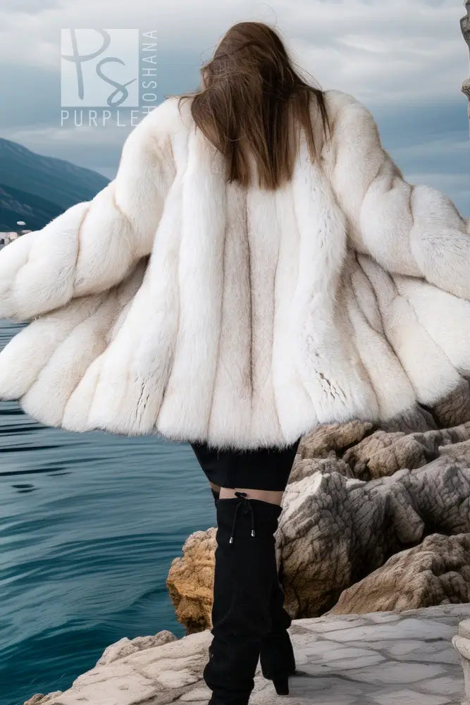 White plush fur jacket with wide layered sleeves and open front, draped look