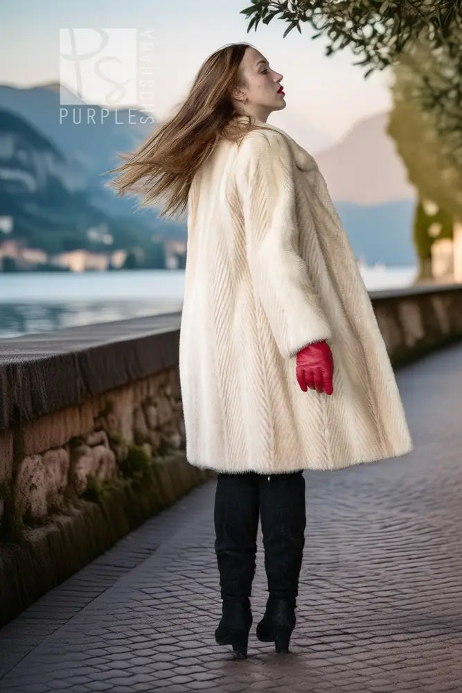Ivory faux mink coat in side profile, full length with plush stand collar