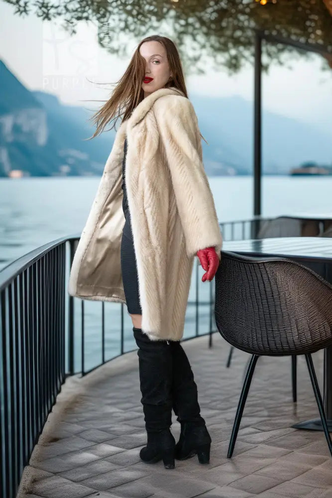 Ivory mink coat side view with plush collar and red gloves