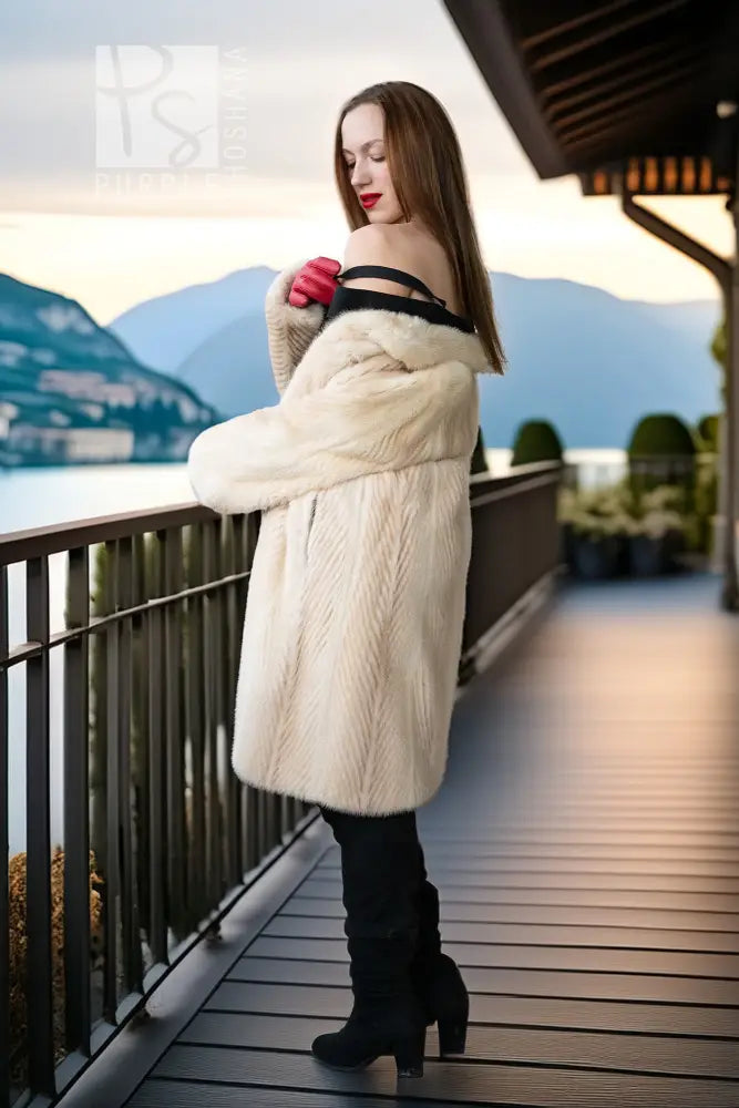 Ivory mink coat, side view with plush texture and draped open-front look.