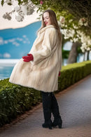 Ivory mink coat with plush collar, long sleeves, red gloves