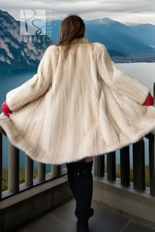Ivory mink coat back view with wide, flared hem and red gloves
