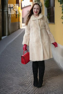 Ivory faux mink coat full front with flared skirt shape and thick fur texture
