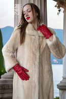 Ivory faux mink coat close-up on collar and sleeves, soft textured fur finish
