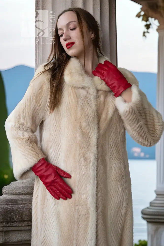 Ivory faux mink coat close-up on collar and sleeves, soft textured fur finish