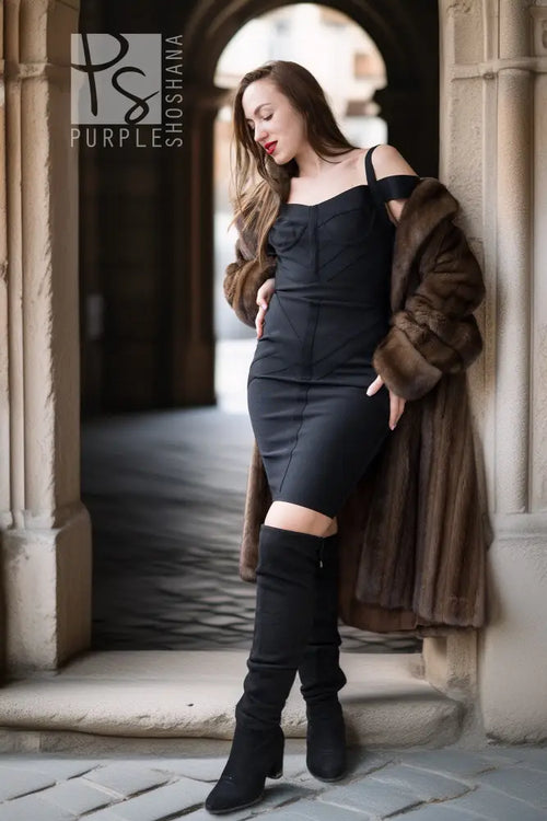 Brown mink swing coat worn over black outfit, fur cuffs and collar