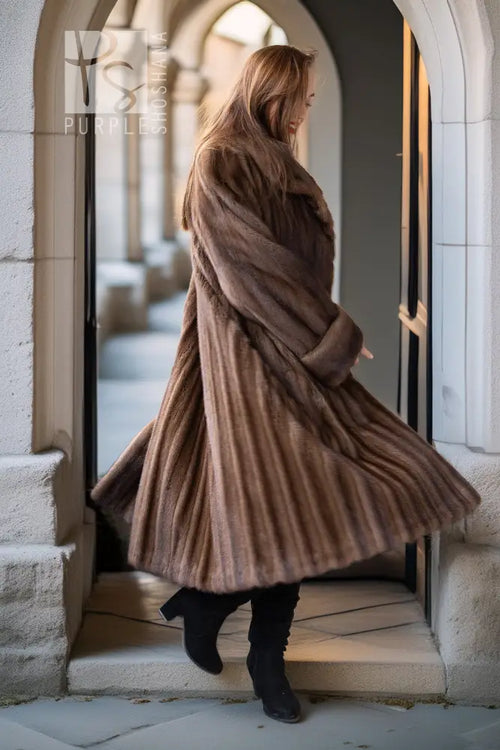 Tan mink swing coat with shawl collar and long sleeves, side view