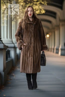 Women’s dark brown mink swing coat with hood, long sleeves, and front button closure.