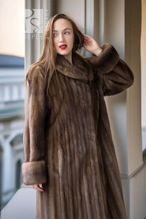 Women’s dark brown mink coat with hood and raised collar, long sleeves, and button front.