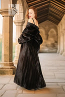 Black fur coat with wide sleeves and high collar, three-quarter side view.