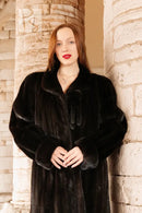 Black mink coat with wide shawl collar and buttonless front