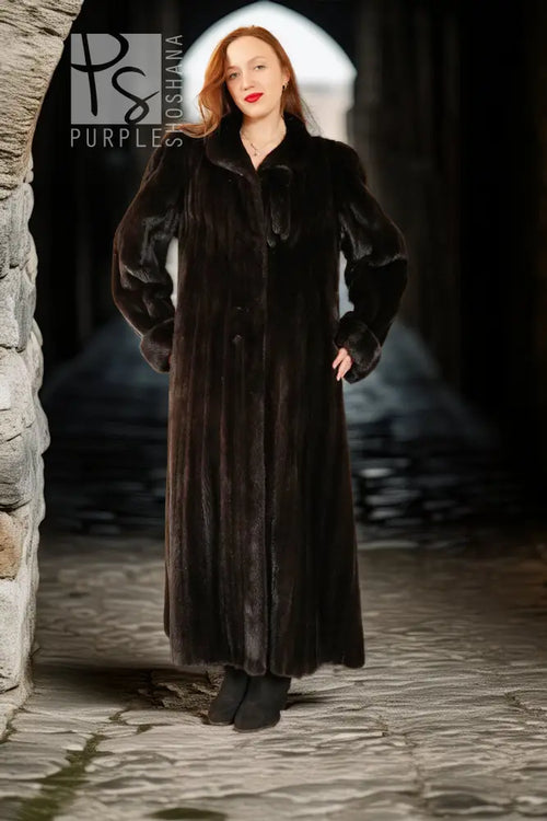 Black mink coat, long length with pointed collar and button front.