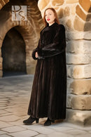 Black designer mink coat, long silhouette with structured high collar.