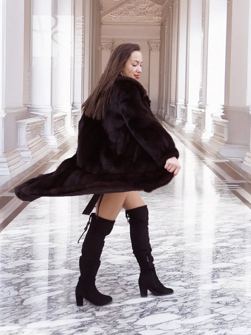 Dark mink fur coat with wide collar and tie belt, long swing hem and full sleeves