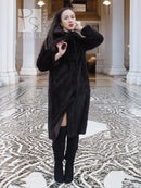 Long mink fur coat with tie belt and wide collar, open front and high textured sleeves